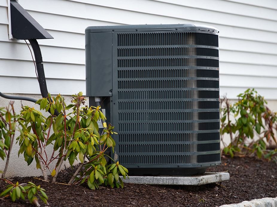 Outdoor air conditioning unit next to a home, representing AC repair and HVAC services in Fort Worth and Arlington, TX.