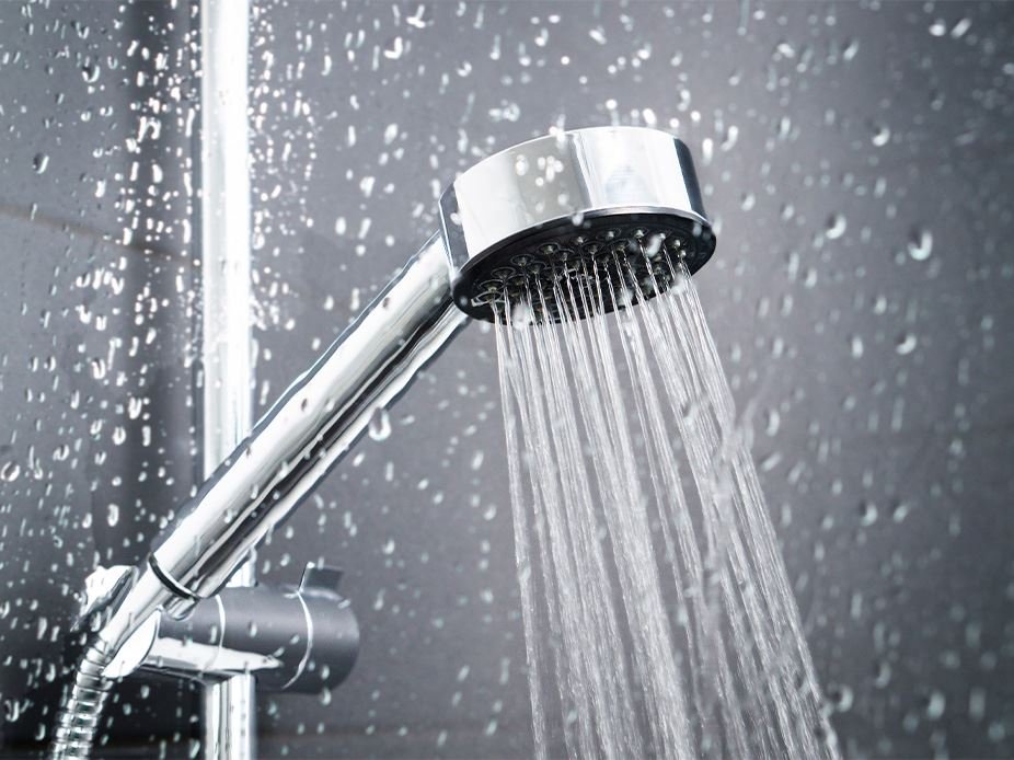 Showerhead releasing steady stream of water, representing plumbing repair and installation services in Fort Worth and Arlington, TX.