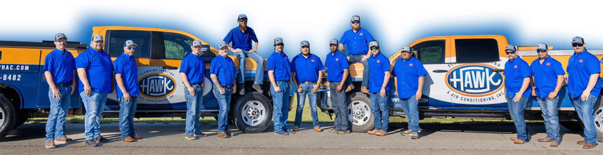 Hawk Plumbing Heating & Air conditioning team in front of company service trucks at Fort Worth, TX, office.